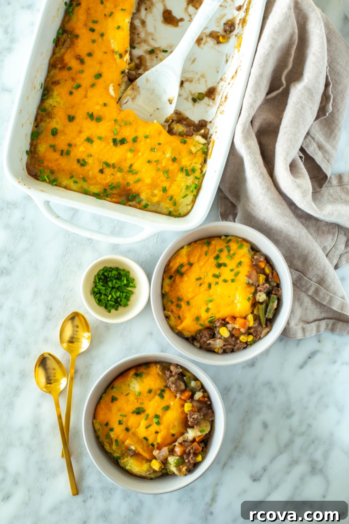 Wholesome Thanksgiving Delights 19 A casserole dish with classic shepherd's pie with two pieces of it in individual bowls.