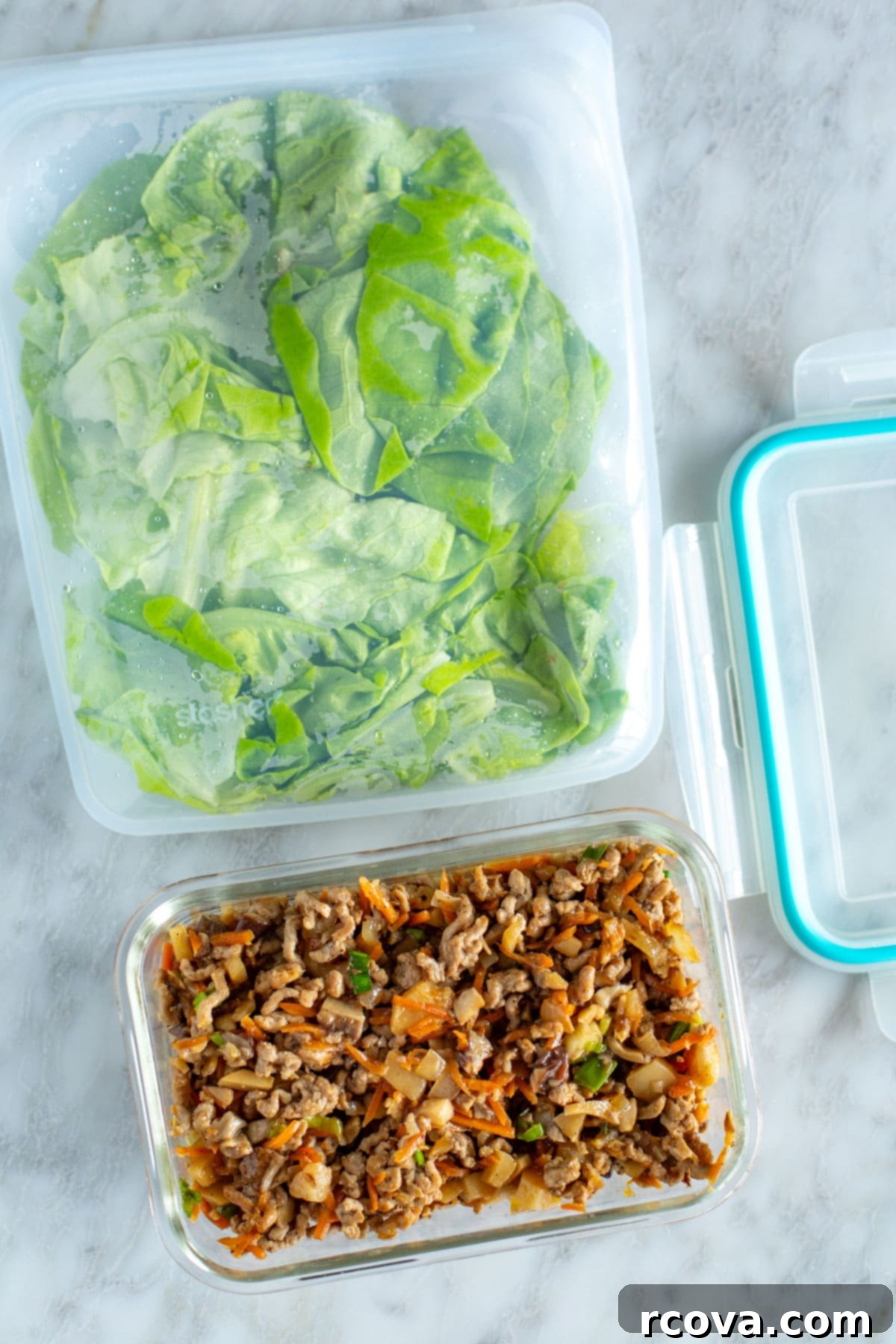 PF Chang's Chicken Lettuce Wraps Just Like The Restaurant 8 PF Chang's chicken mixture in a glass container with lettuce leaves in a Ziploc bag beside it, demonstrating meal prep storage.