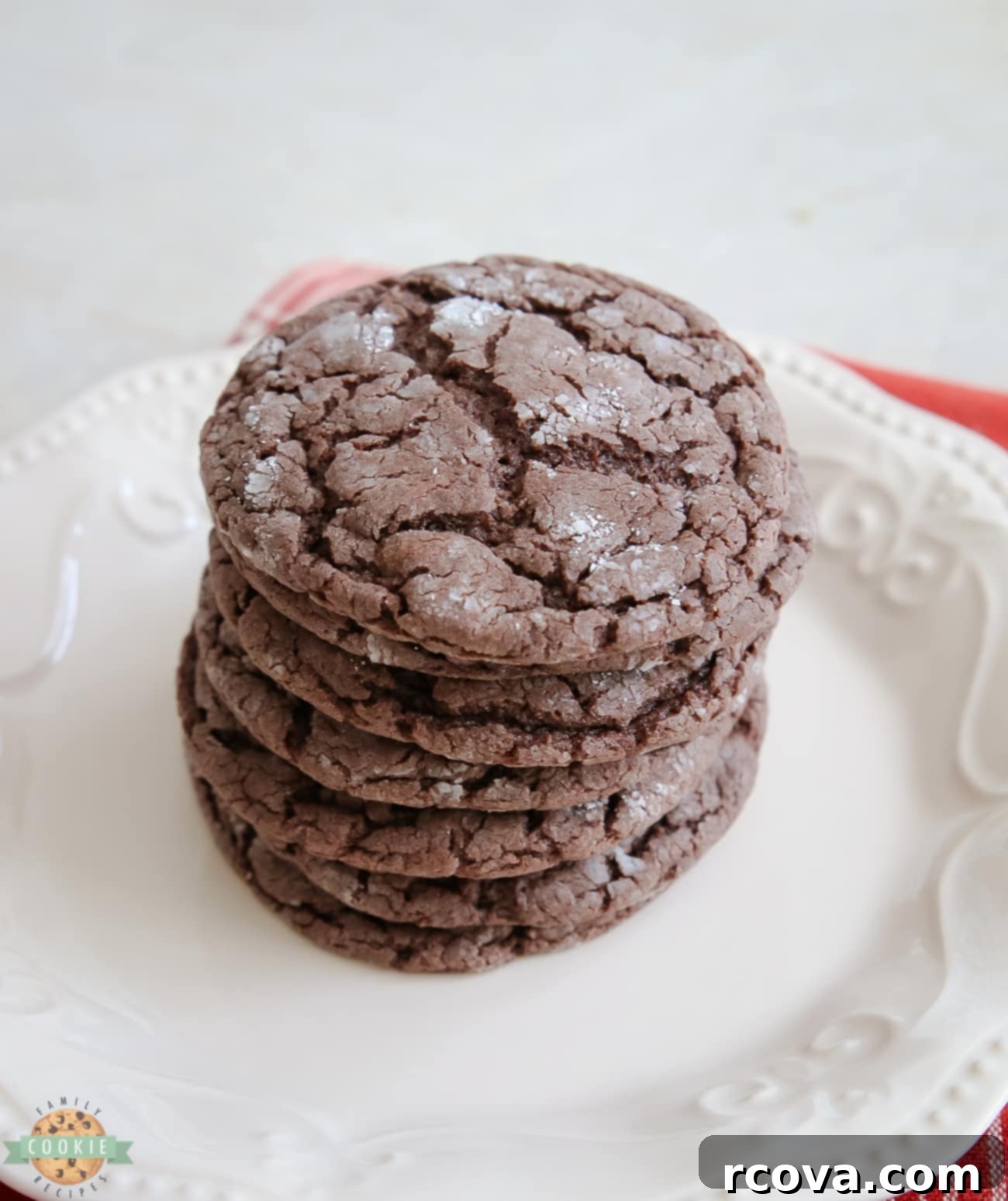 Festive Cocoa Crinkles 3 Stack of fluffy, spiced chocolate cake mix cookies, showcasing their inviting texture and powdered sugar coating.