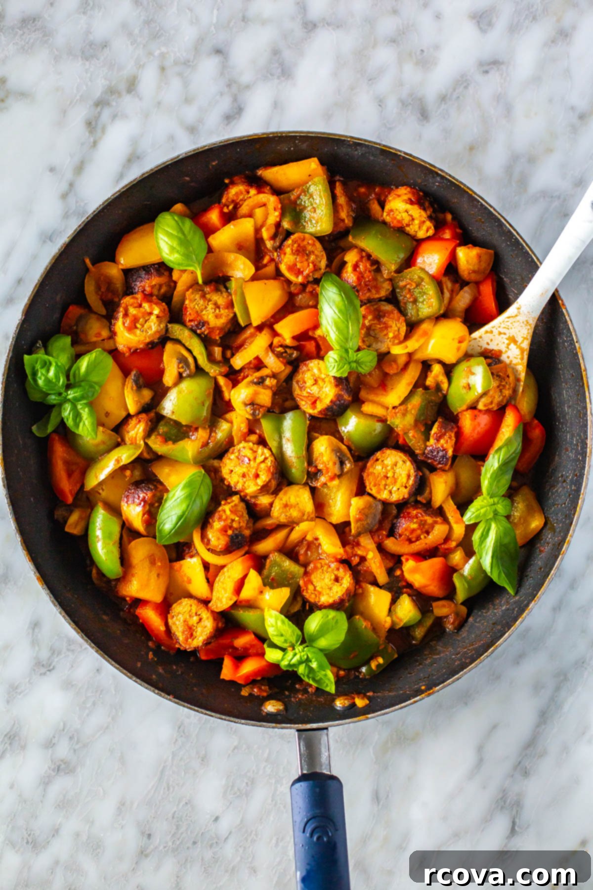 Effortless Weekly Meal Prep 17 A sizzling skillet filled with colorful sausage, peppers, and onions, ready for a delicious and easy weeknight dinner.