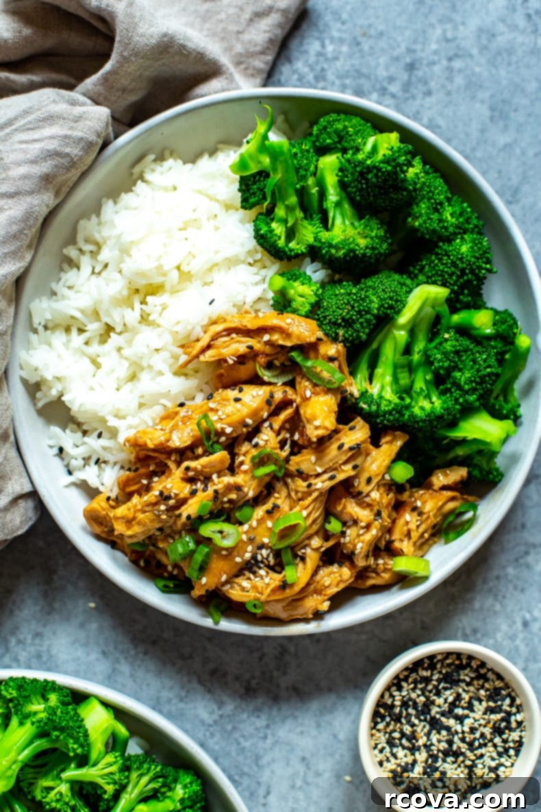 Effortless Weekly Meal Prep 21 A single bowl brimming with fluffy white rice, savory chicken teriyaki, and perfectly steamed broccoli, beautifully garnished with sesame seeds and vibrant green onions.