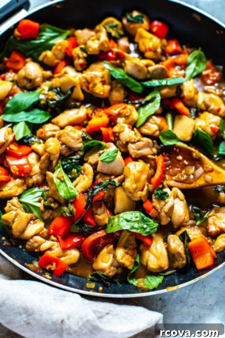 Skillet Thai Basil Chicken for Quick & Easy Cooking A large skillet pan brimming with delicious Meal Prep Thai Basil Chicken, ready to be served or portioned.