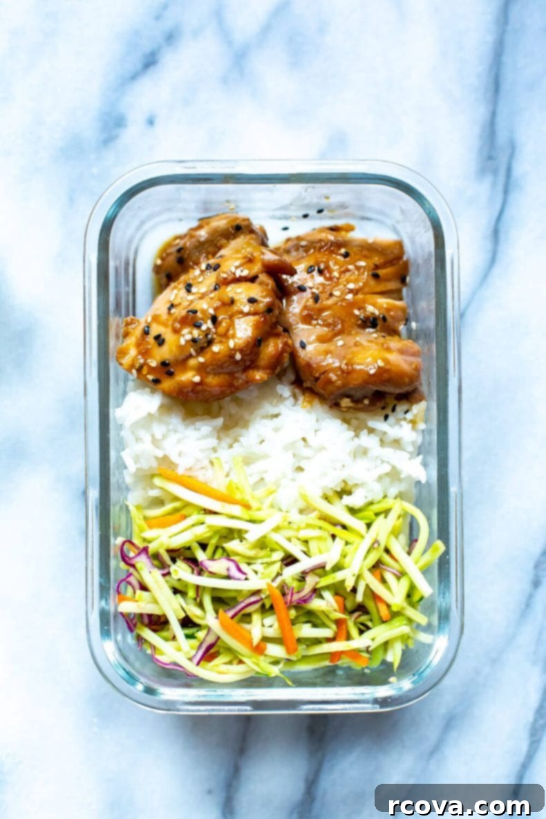 These Garlic Sesame Instant Pot Chicken Thighs are perfect for your weekly meal prep and they are covered in the best sticky, sweet sauce - serve with rice and veggies for a full meal! #instantpot #chickenthighs Meal prep dinner featuring juicy Garlic Sesame Chicken Thighs, fluffy white rice, and crisp broccoli slaw, arranged beautifully for a complete meal
