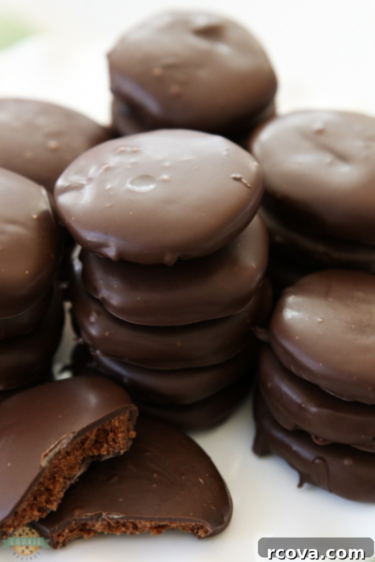 Ultimate Chocolate Mint Cookies 4 Thin Mints Cookies made with homemade buttery chocolate cookies dipped in a shiny mint fudge glaze, arranged on a cooling rack.