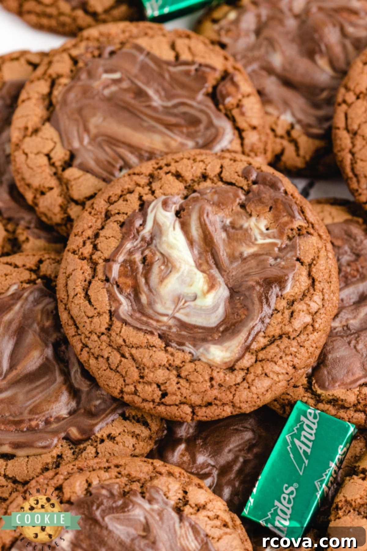 Ultimate Chocolate Mint Cookies 7 Chewy Andes Mint Chocolate Cookies, each frosted with a smooth, melted Andes mint layer, stacked on a white plate.