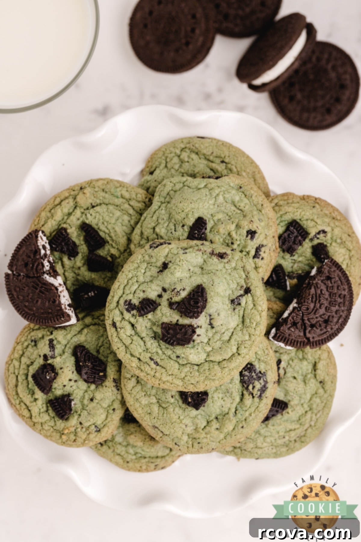 Ultimate Chocolate Mint Cookies 8 Mint Oreo Pudding Cookies, soft and chewy with visible Oreo pieces and a minty green hue, on a white surface.