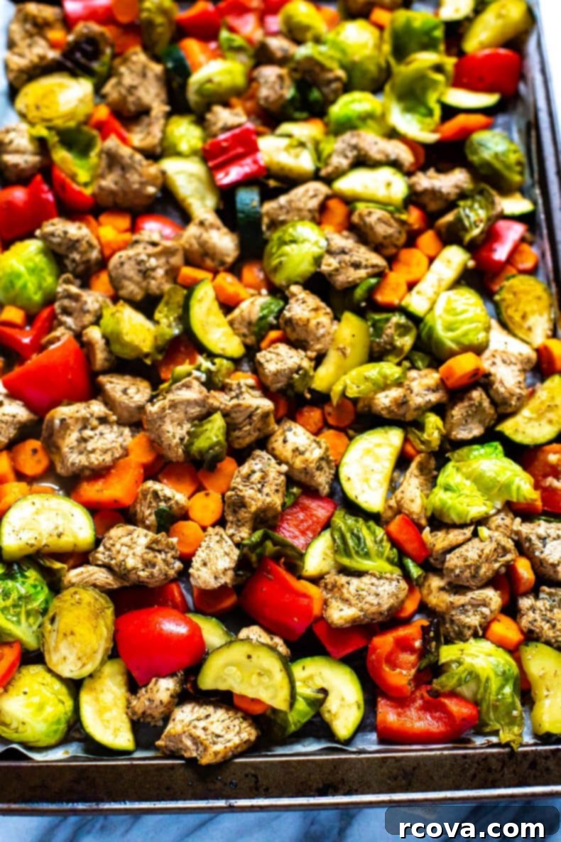 This Sheet Pan Balsamic Chicken is a delicious, healthy weeknight dinner idea. It comes together on one pan, ready to eat in 30 minutes! Leftovers won’t be a problem with this flavourful chicken dinner - turn them into meal prep lunches for the week! pieces of marinated chicken breast and fresh vegetables on a sheet pan, ready for roasting