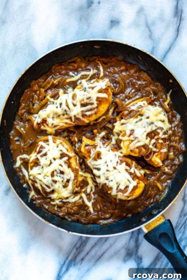 This French Onion Chicken Skillet is a delicious weeknight dinner that is a play on French onion soup and packed with protein, making it a full meal. This will become one of your favorite chicken skillet recipes! French Onion Chicken Skillet served with roasted broccoli, ready to eat.