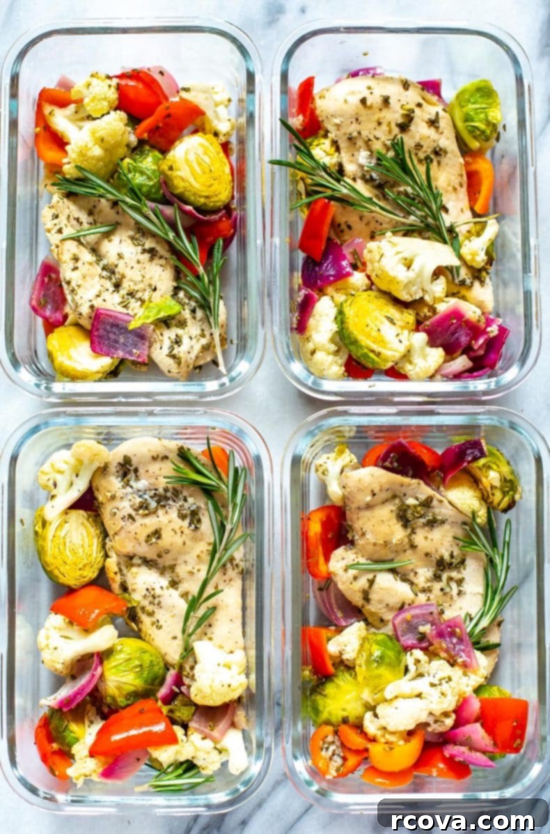 Our Sheet Pan Rosemary Chicken is a healthy, low-carb chicken meal prep recipe. It's perfect as a 30-minute dinner or to pack up as weekly lunch bowls!  Four meal prep containers filled with healthy portions of Sheet Pan Rosemary Chicken and a colorful mix of roasted vegetables, perfectly portioned for the week.