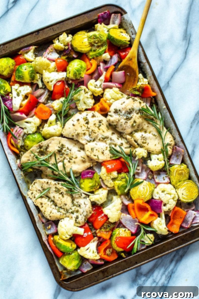 Our Sheet Pan Rosemary Chicken is a healthy, low-carb chicken meal prep recipe. It's perfect as a 30-minute dinner or to pack up as weekly lunch bowls!  A vibrant, low-carb chicken dinner featuring roasted chicken and a colorful medley of vegetables generously seasoned with rosemary, all cooked together on a single sheet pan.
