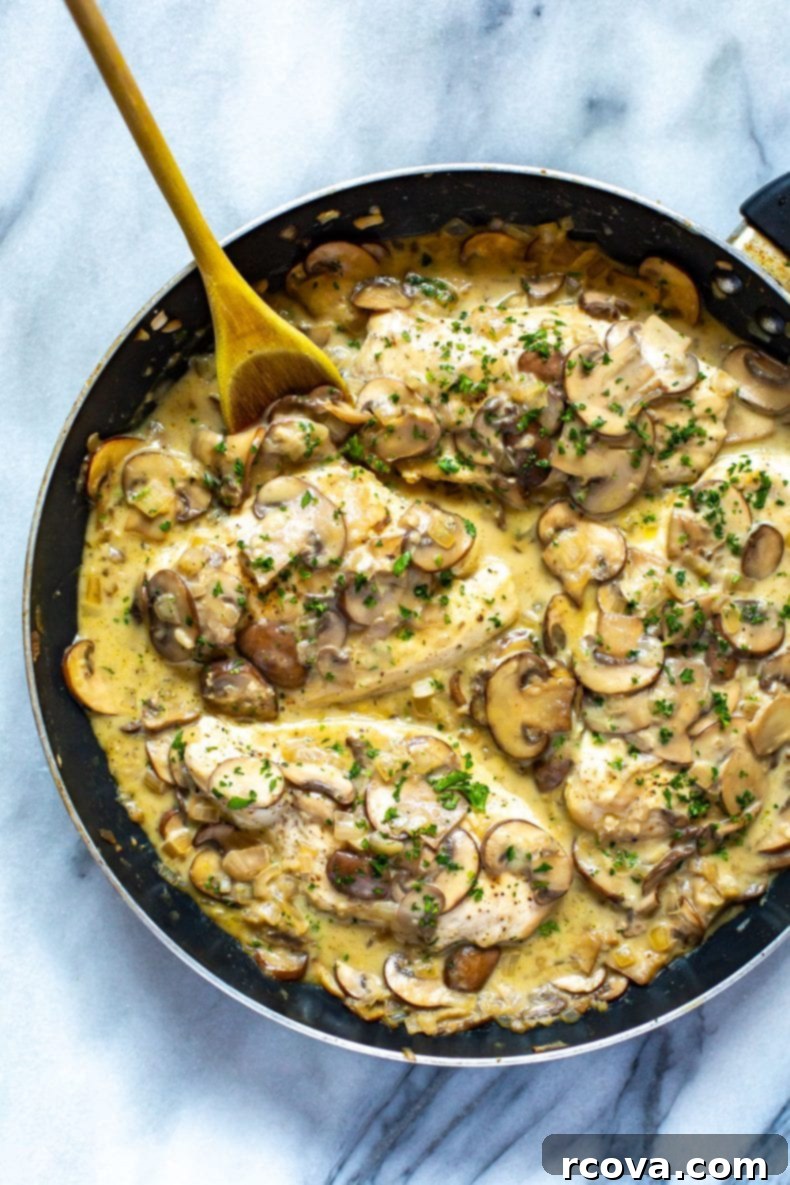 This Skinny, Easy Chicken Marsala Skillet is a delicious, creamy mushroom chicken recipe, made healthier with less cream and Marsala wine. It's a one-pan dinner that's freezer-friendly! Skinny Easy Chicken Marsala in a skillet, showcasing a creamy mushroom chicken dish ready to serve