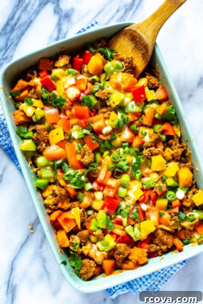 Healthy Ground Turkey Taco Casserole: A delicious, healthier meal prep take on taco dinner with ground turkey, sweet potatoes, and bell peppers. Ideal for nutritious lunch or dinner! Healthy Taco Casserole with ground turkey, sweet potatoes, and bell peppers, topped with cheese and fresh herbs.