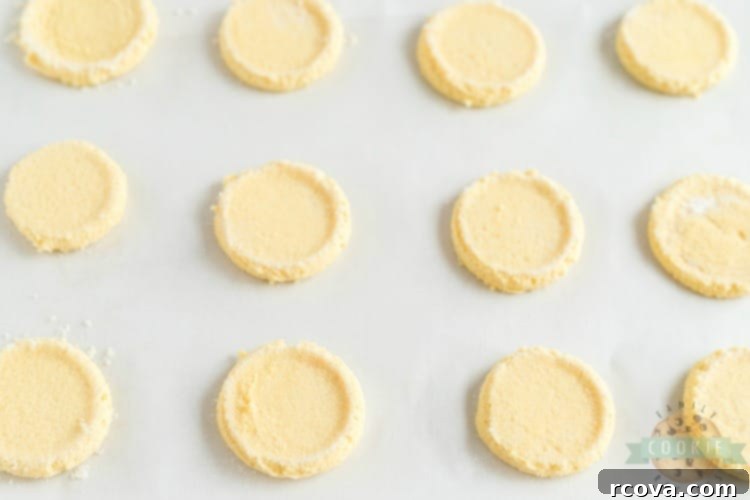 Vibrant Lemon Jello Sugar Cookies 8 Dough balls for lemon jello sugar cookies being flattened with a sugar-coated glass