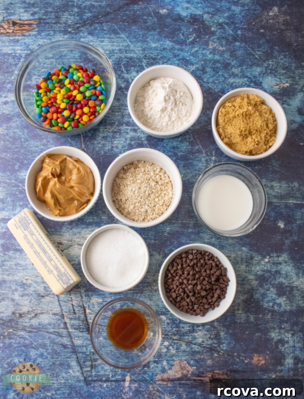 No-Bake Monster Cookie Dough 4 All the fresh ingredients laid out for making Edible Monster Cookie Dough: butter, sugars, peanut butter, milk, vanilla, flour, oats, M&Ms, and chocolate chips.