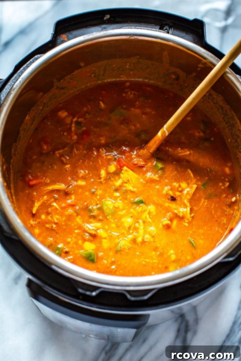 This Instant Pot Chicken Enchilada Soup is a delicious copycat of Chili's enchilada soup recipe. It's made healthier and easily using pantry staples! You'll love this Mexican soup!  Chicken Enchilada Soup in an electric pressure cooker