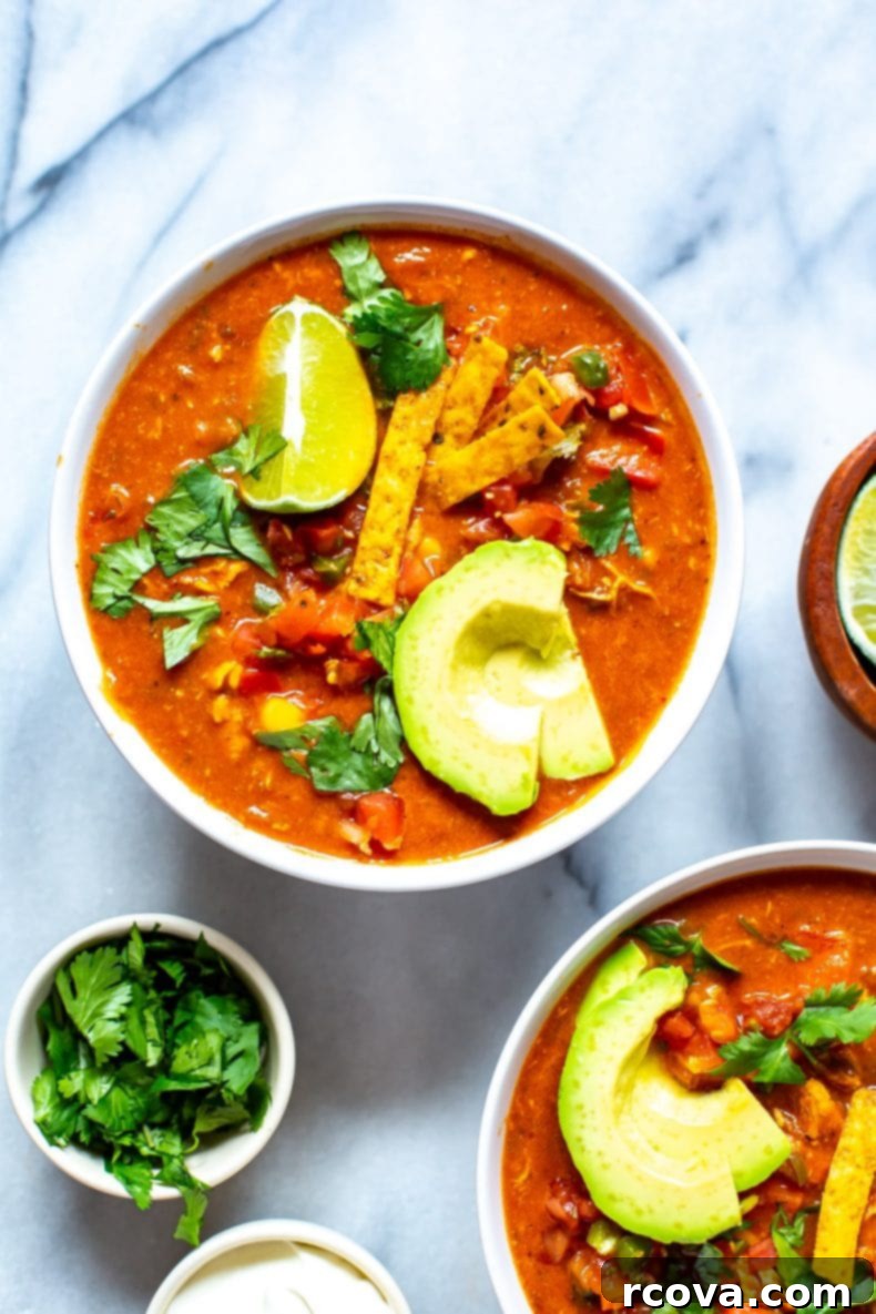 This Instant Pot Chicken Enchilada Soup is a delicious copycat of Chili's enchilada soup recipe. It's made healthier and easily using pantry staples! You'll love this Mexican soup!  homemade version of Chili's Chicken Enchilada Soup recipe