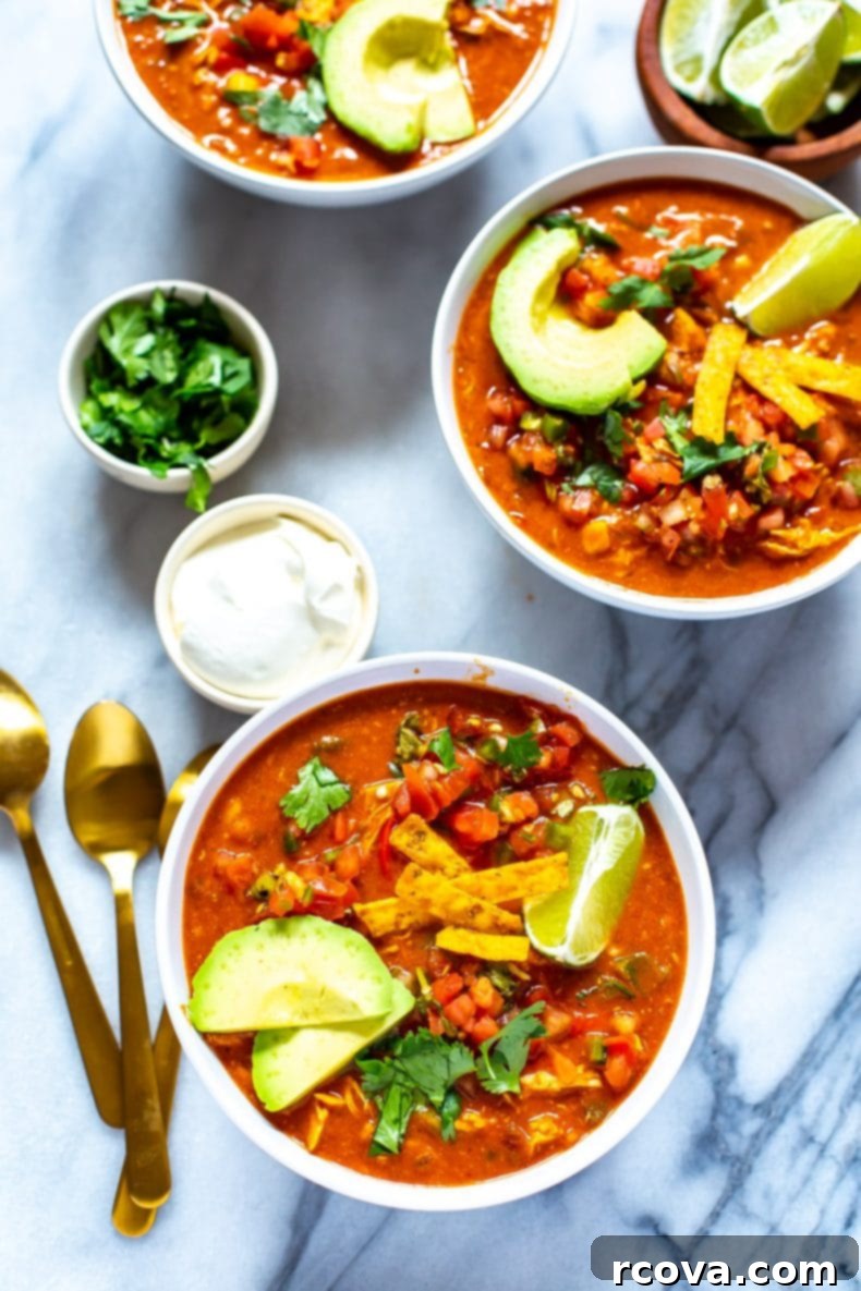 This Instant Pot Chicken Enchilada Soup is a delicious copycat of Chili's enchilada soup recipe. It's made healthier and easily using pantry staples! You'll love this Mexican soup!  Pressure Cooker Chicken Enchilada Soup in white soup bowls