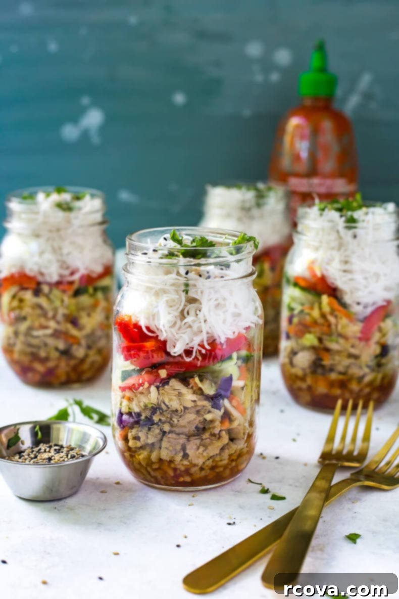 Your First 7 Steps to Stress-Free Meal Prep 7 Three chicken spring roll jars in the background with one chicken spring roll jar in the foreground.