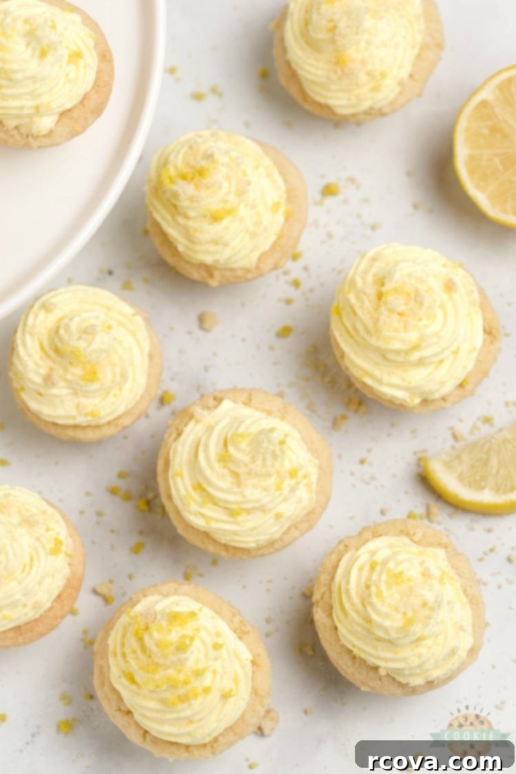 Zesty Lemon Cloud Cookies 4 A stunning overhead view of Lemon Cream Pie Cookies presented on a clean white surface, highlighting their delicate texture and the creamy filling garnished with bright yellow lemon zest.