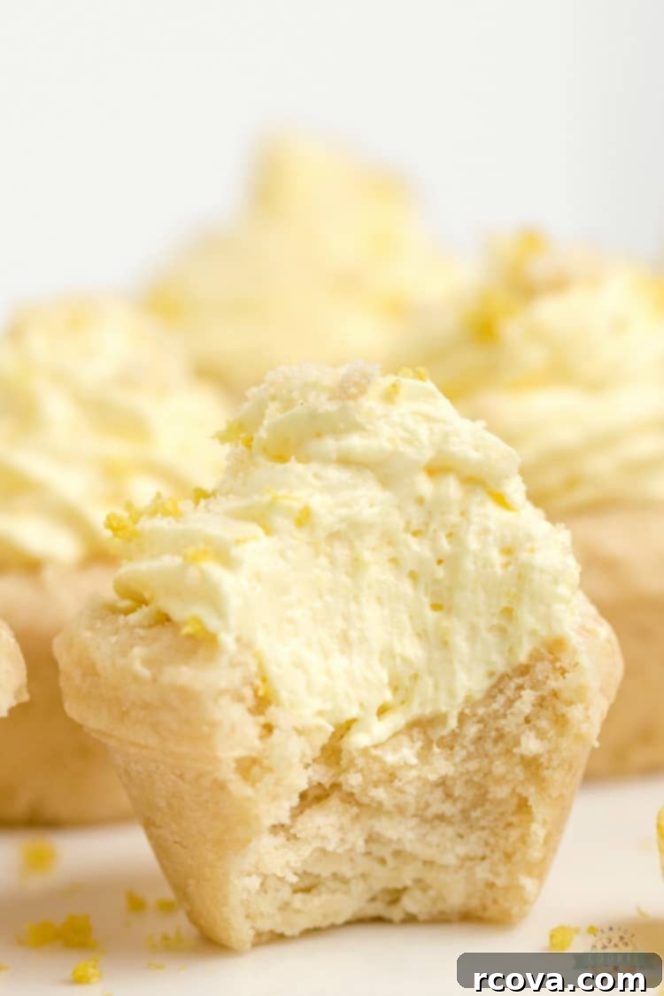 Zesty Lemon Cloud Cookies 10 A vibrant display of Lemon Cream Pie Cookies, each perfectly formed and topped with a swirl of lemon cream and a sprinkle of fresh zest, ready for a spring gathering.