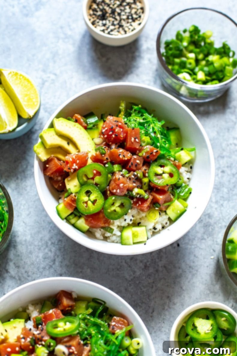 This 30-Minute Ahi Poke Bowl is a quick Hawaiian-inspired recipe with marinated tuna, sushi rice, avocado and seaweed salad - it's just like takeout! A vibrant Ahi Tuna Poke Bowl in a clean white bowl, garnished with fresh ingredients.