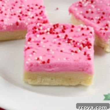 Delicious Sugar Cookie Bars 6 Sugar Cookie Bars with pink frosting and sprinkles