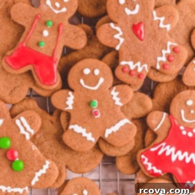 Warm Gingerbread Delights 14 Assorted decorated gingerbread cookies stacked on a cooling rack