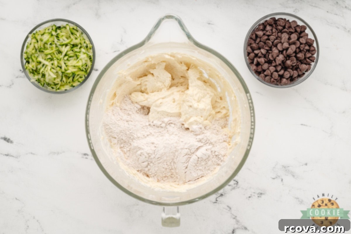 Hidden Veggie Chocolate Chip Delights 7 Dry ingredients including flour, cinnamon, baking powder, baking soda, and salt being added to the wet cookie dough mixture.