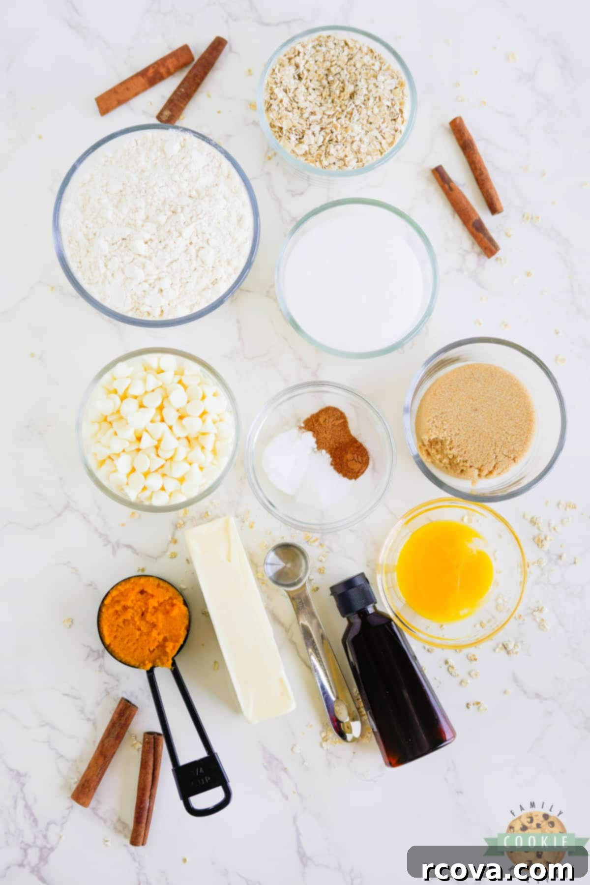 Golden Pumpkin White Chocolate Oat Jewels 4 Ingredients for White Chocolate Chip Pumpkin Oatmeal Cookies laid out on a surface, ready for baking preparation.