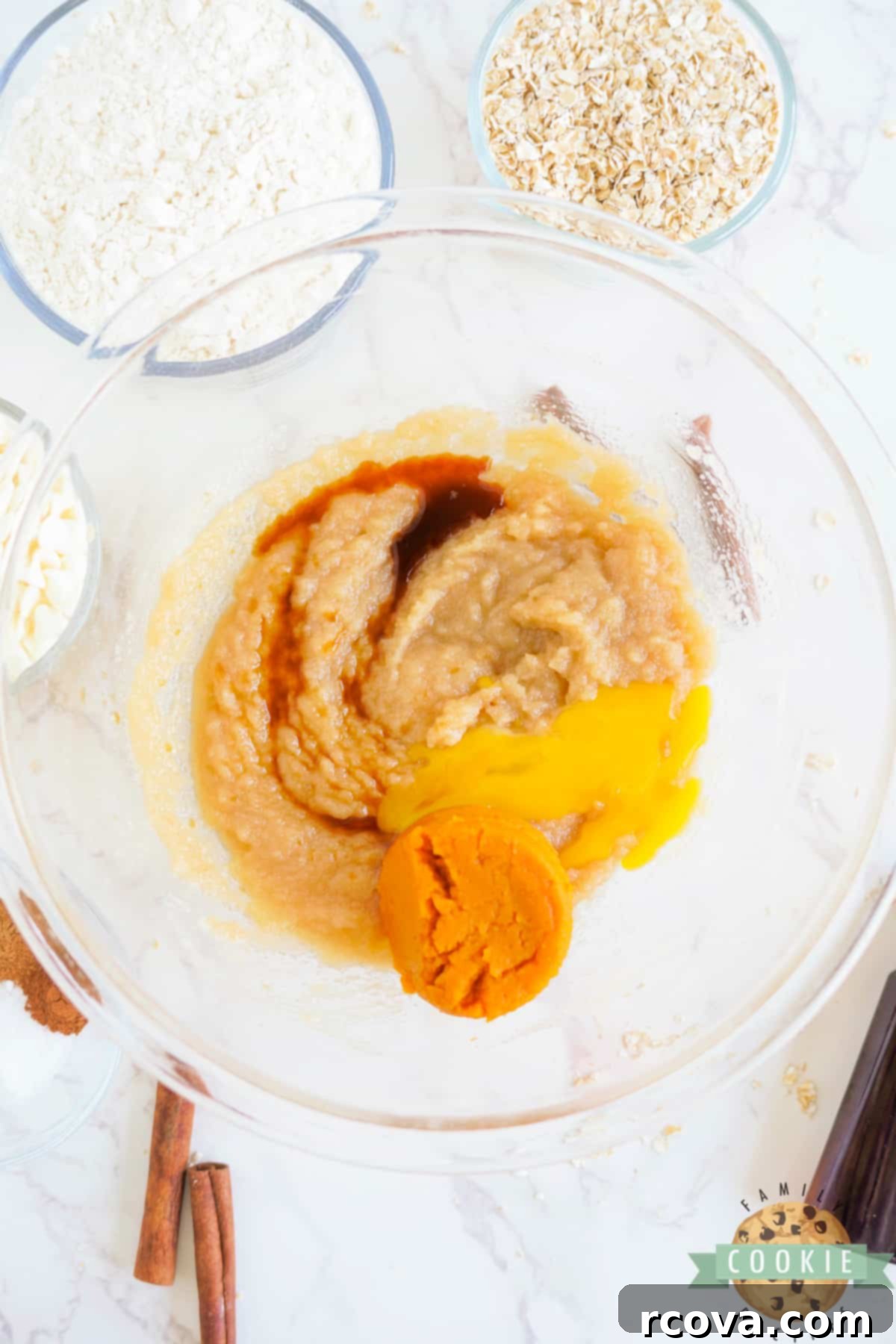 Golden Pumpkin White Chocolate Oat Jewels 7 Adding pumpkin puree, egg yolk, and vanilla extract to the creamed butter and sugar mixture.