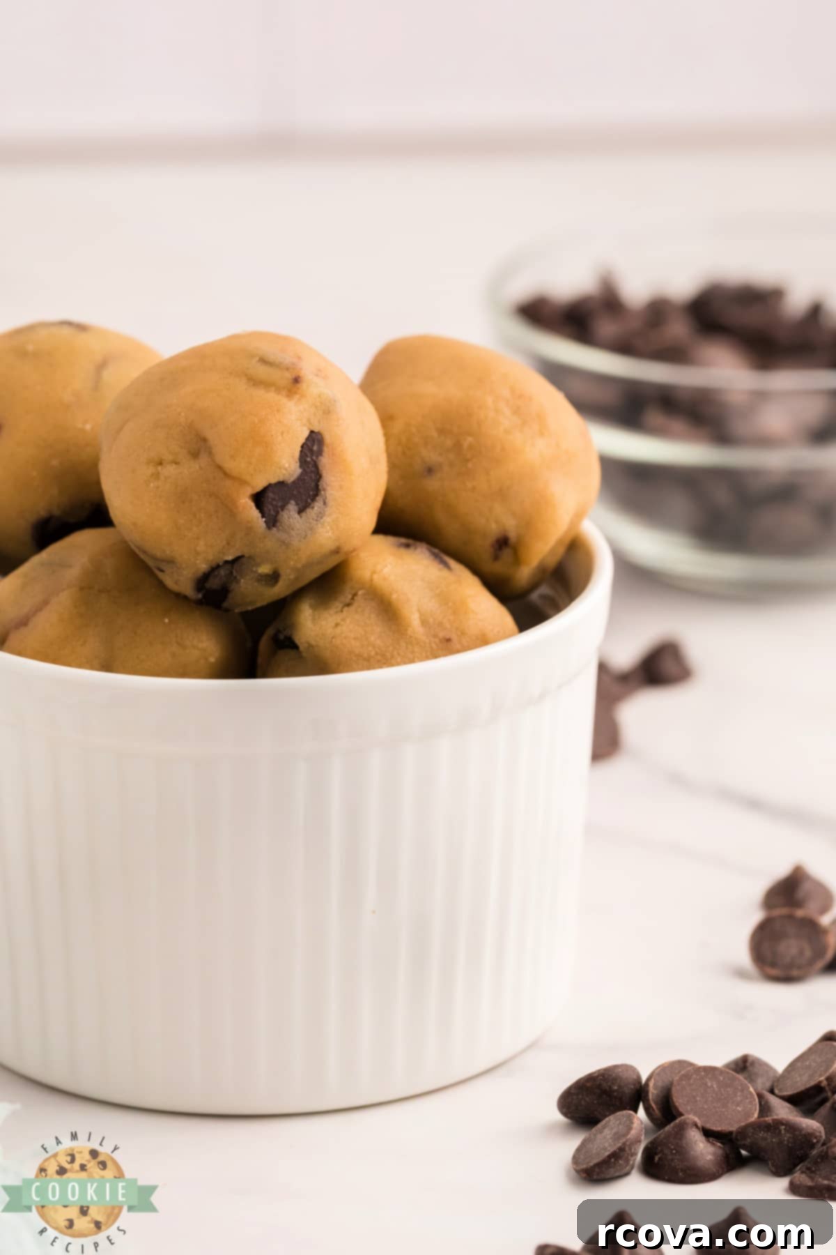 Indulgent Chocolate Chip Dough Gems 5 A close-up shot of several edible chocolate chip cookie dough bites, showing their texture and the distribution of chocolate chips.