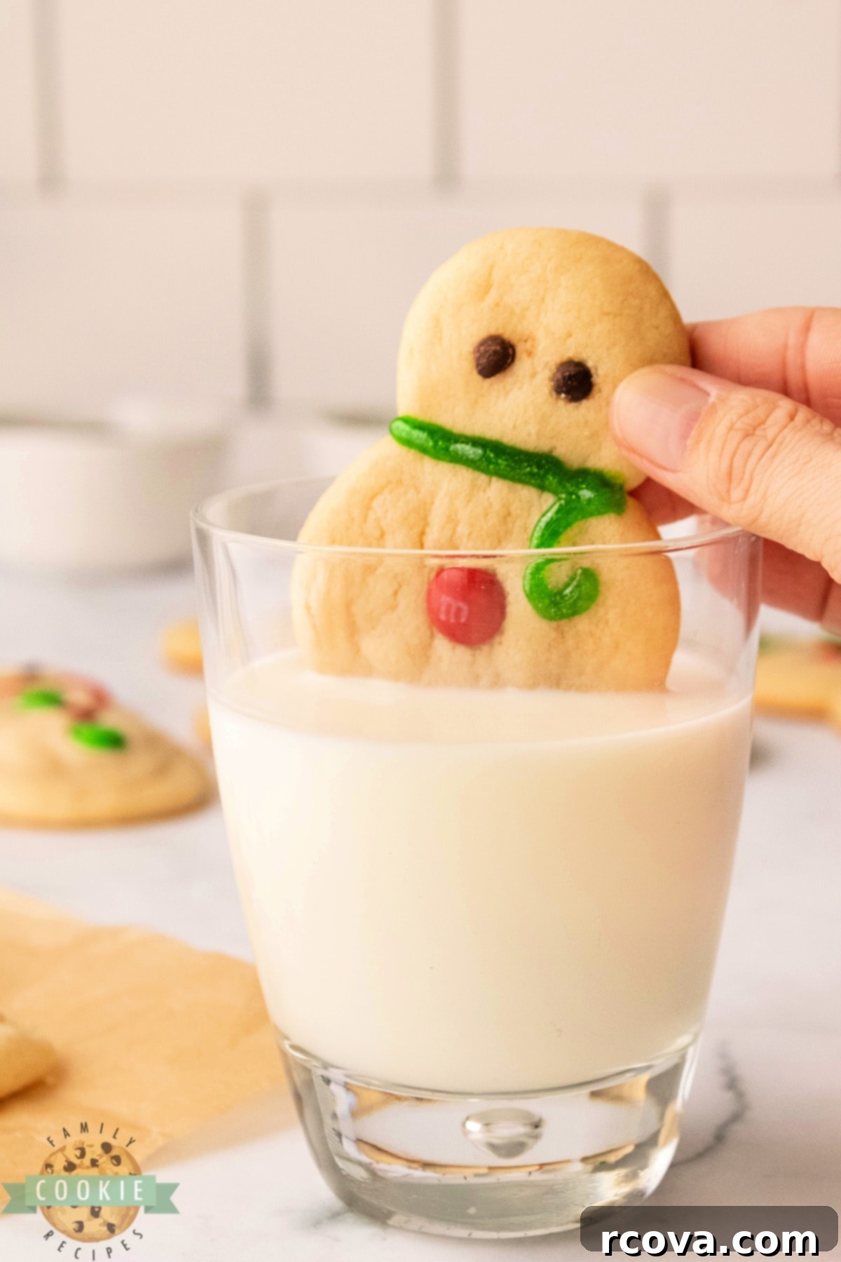 Sweet Snowman Delights 3 Dipping sugar cookie in a glass of milk.