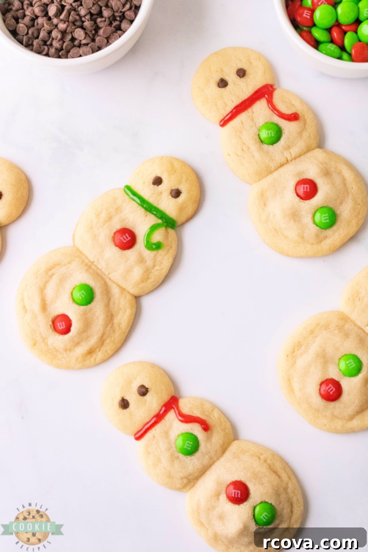 Sweet Snowman Delights 8 A batch of freshly baked snowman sugar cookies cooling on a wire rack.