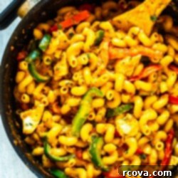 Velvet Cajun Chicken Pasta 6 A large pot of creamy Cajun chicken pasta, featuring perfectly cooked noodles, tender chicken pieces, and vibrant bell peppers, ready to be served.