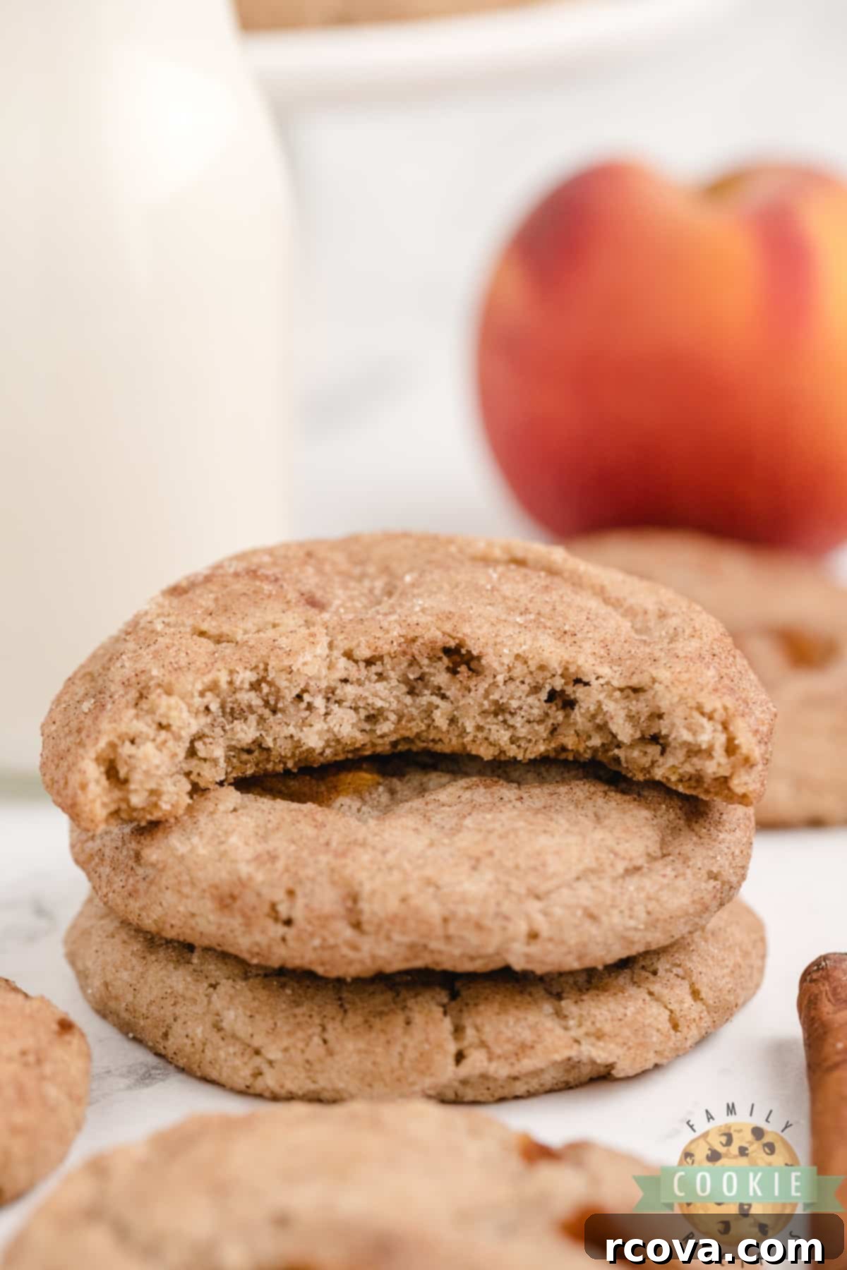 Golden Peach Snickerdoodle Delights 2 Delicious Peach Snickerdoodle Cookies on a cooling rack, showcasing their soft texture and cinnamon-sugar coating
