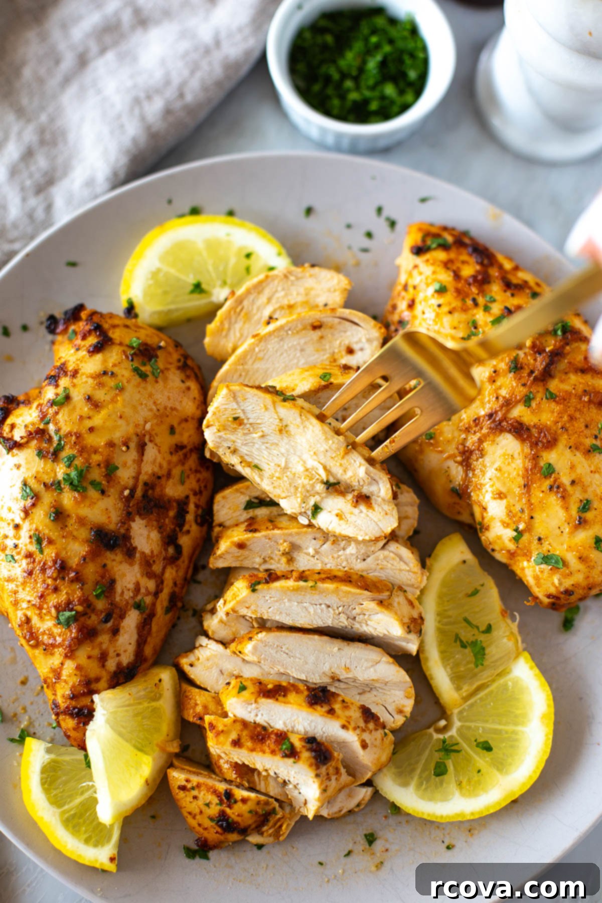 Ultimate Marinated Chicken Breast Perfection 2 Sliced marinated chicken breast on a plate, showcasing its juiciness and rich color.