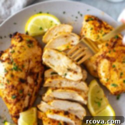 Ultimate Marinated Chicken Breast Perfection 10 Sliced marinated chicken breast on a plate, showcasing its juiciness and rich color, ready to be served.