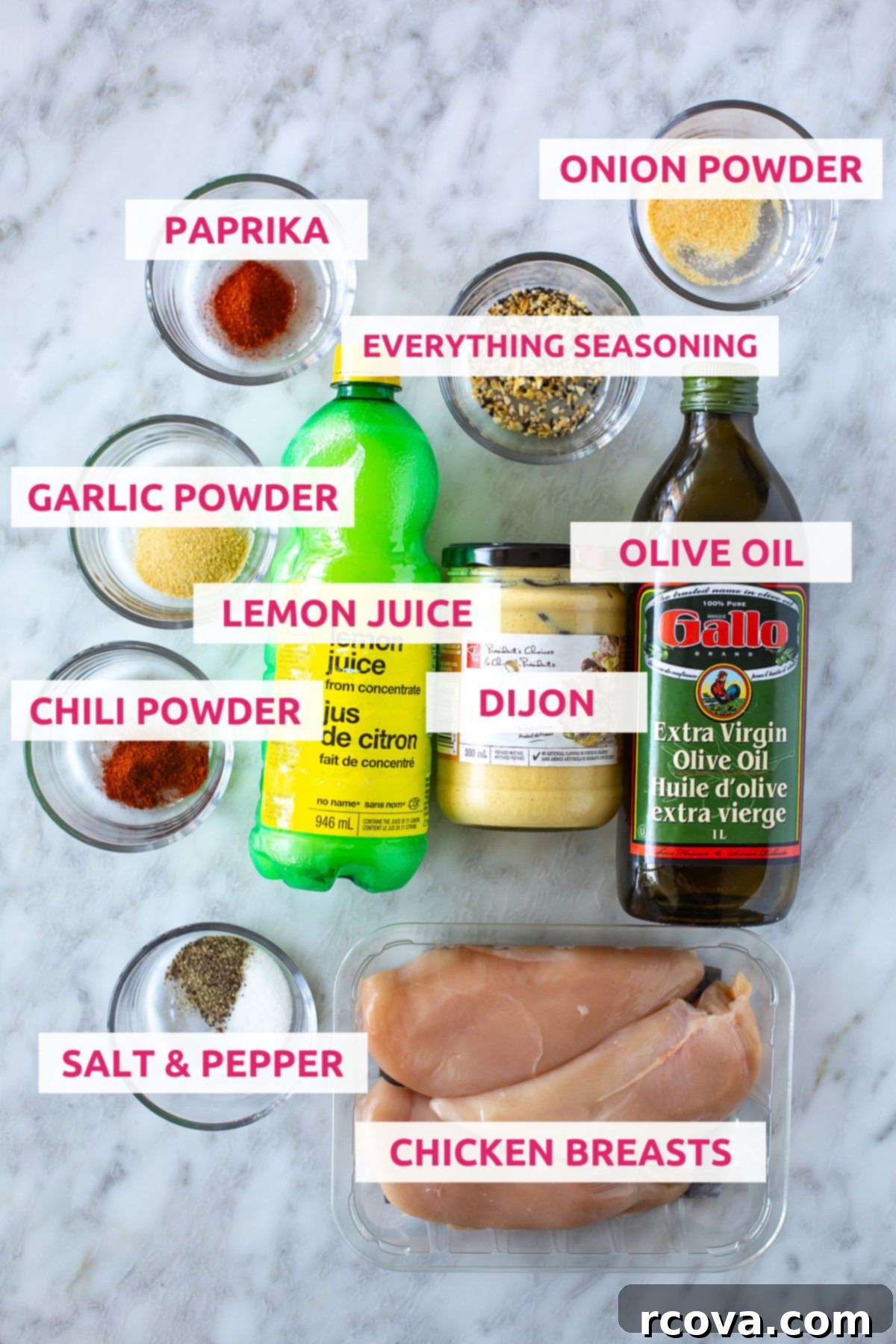 Ultimate Marinated Chicken Breast Perfection 4 Ingredients for making marinated chicken breast laid out: chicken breasts, olive oil, lemon juice, Dijon mustard, paprika, chili powder, onion powder, garlic powder, salt and pepper, everything bagel seasoning.