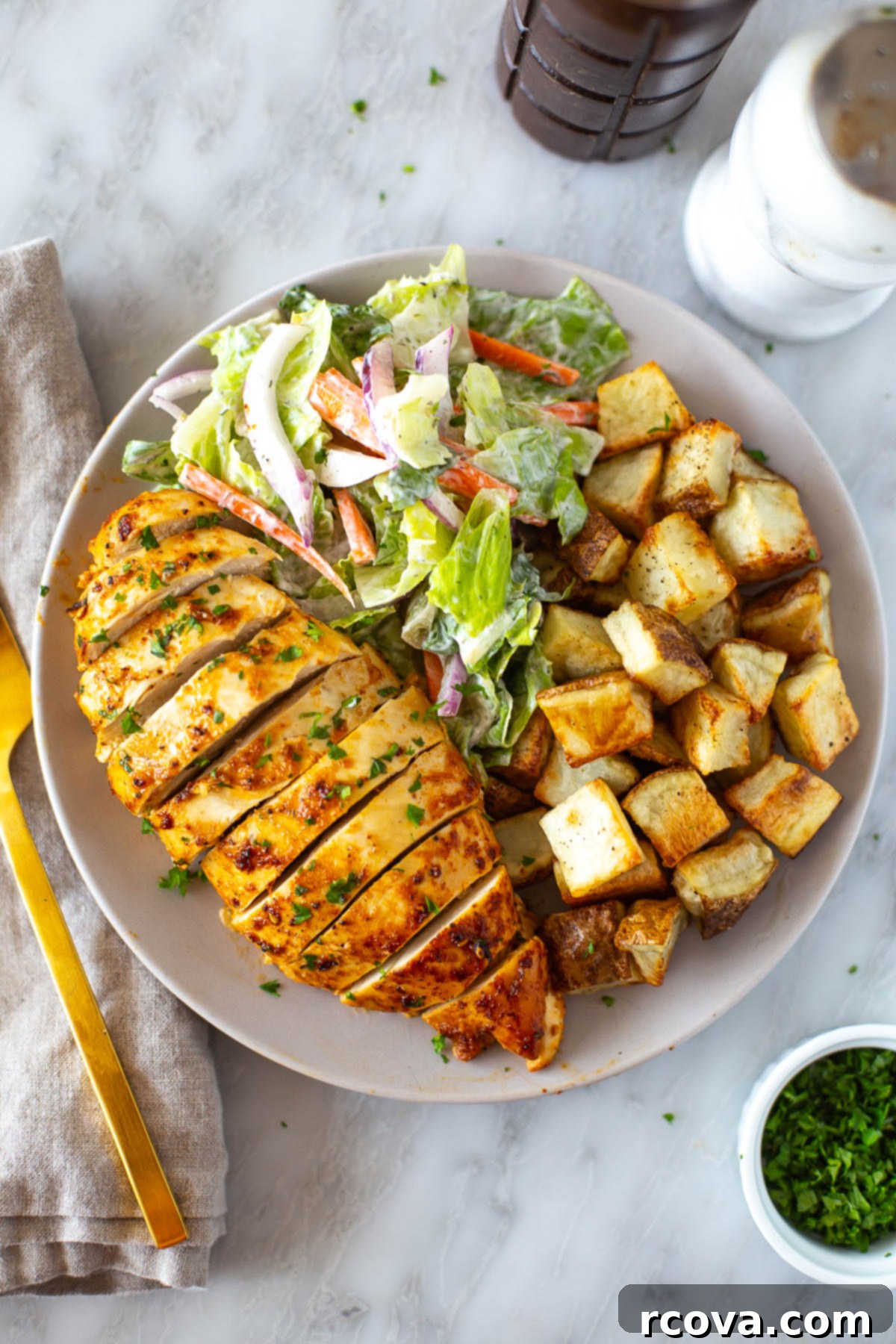 Ultimate Marinated Chicken Breast Perfection 7 Overhead shot of marinated chicken breast with a side of diced potatoes and salad, ready to be served.
