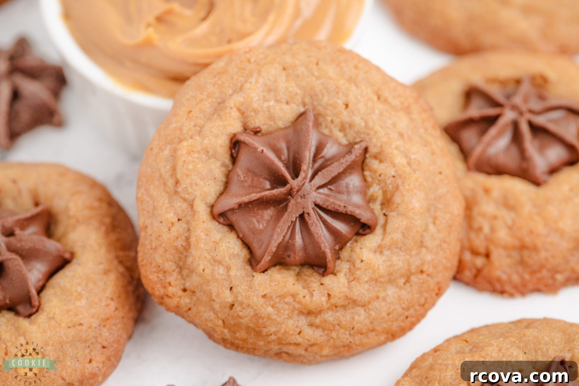 Effortless Peanut Butter Blossoms 2 easiest ever peanut butter kiss cookies, fresh out of the oven, topped with chocolate kisses