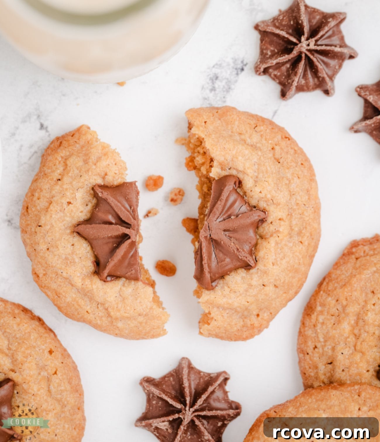 Effortless Peanut Butter Blossoms 6 peanut butter kiss cookie broken in half, showing the soft interior