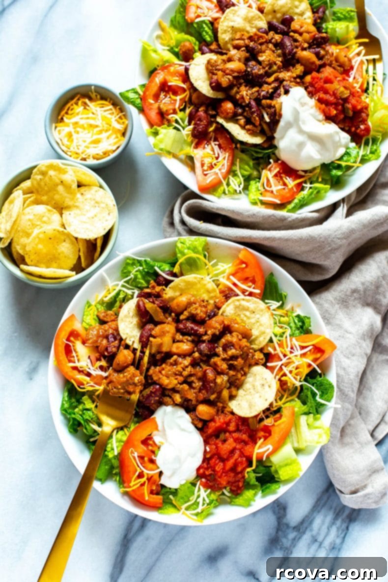 Make the best Wendy's Taco Salad at home with this easy copycat recipe, including the classic Wendy's chili! Homemade version of Wendy's Taco Salad, served in a bowl, showcasing fresh ingredients and rich chili.