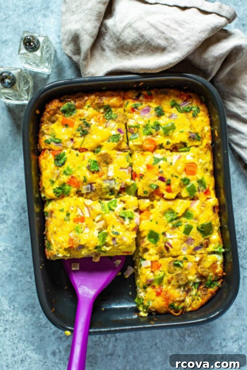This Sausage Hashbrown Breakfast Casserole is made healthier thanks to turkey breakfast sausage and less cheese - it's a great meal prep idea that is also freezer-friendly! Removing a serving of golden-brown sausage hashbrown breakfast casserole from a pan, ready to enjoy.