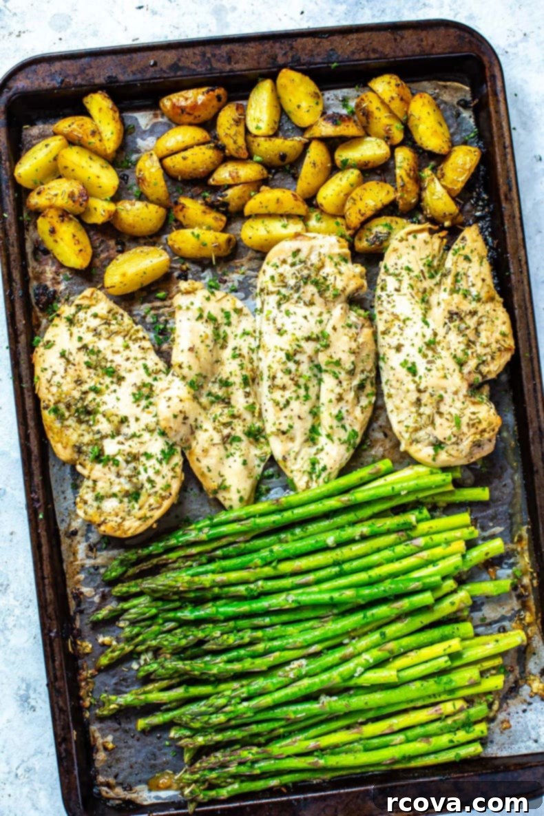 How to Meal Prep for Weight Loss with a Diet Plan 15 A sheet pan with roasted potatoes, seasoned chicken breasts, and asparagus on top.