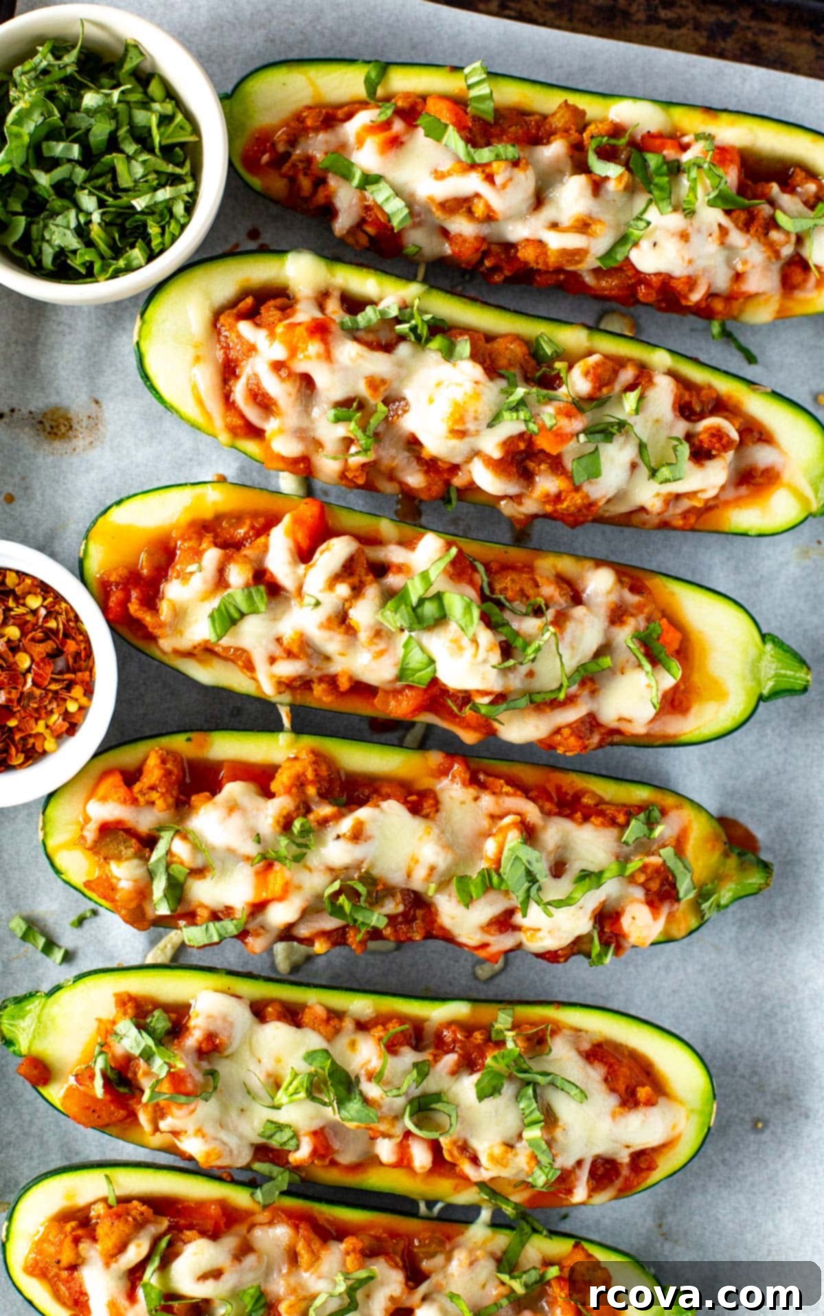 Quick and Flavorful Italian Zucchini Boats 2 Overhead shot of vibrant Italian stuffed zucchini boats, brimming with a rich meat sauce and golden-brown mozzarella, ready to be served.