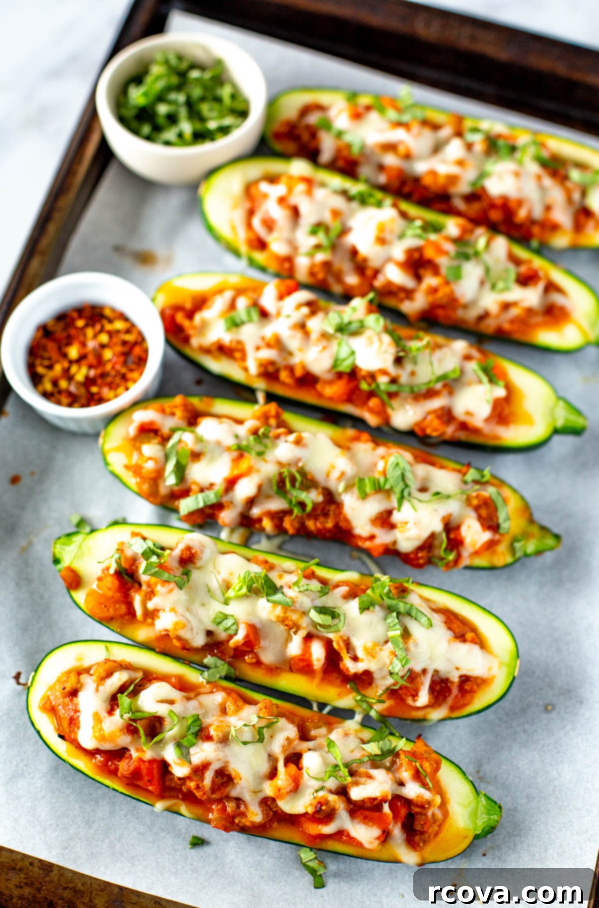 Quick and Flavorful Italian Zucchini Boats 9 Overhead shot of two freshly baked Italian stuffed zucchini boats, garnished with basil and ready to be enjoyed as a healthy and delicious meal.