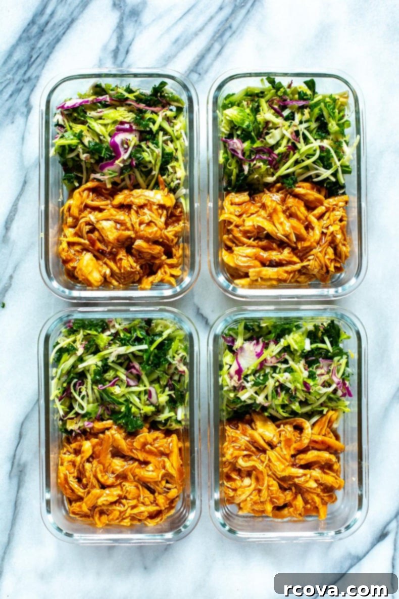 Effortless 2-Ingredient Slow Cooker BBQ Chicken 7 Four glass meal prep containers filled with shredded crockpot BBQ chicken and a side of fresh kale slaw, ready for the week.