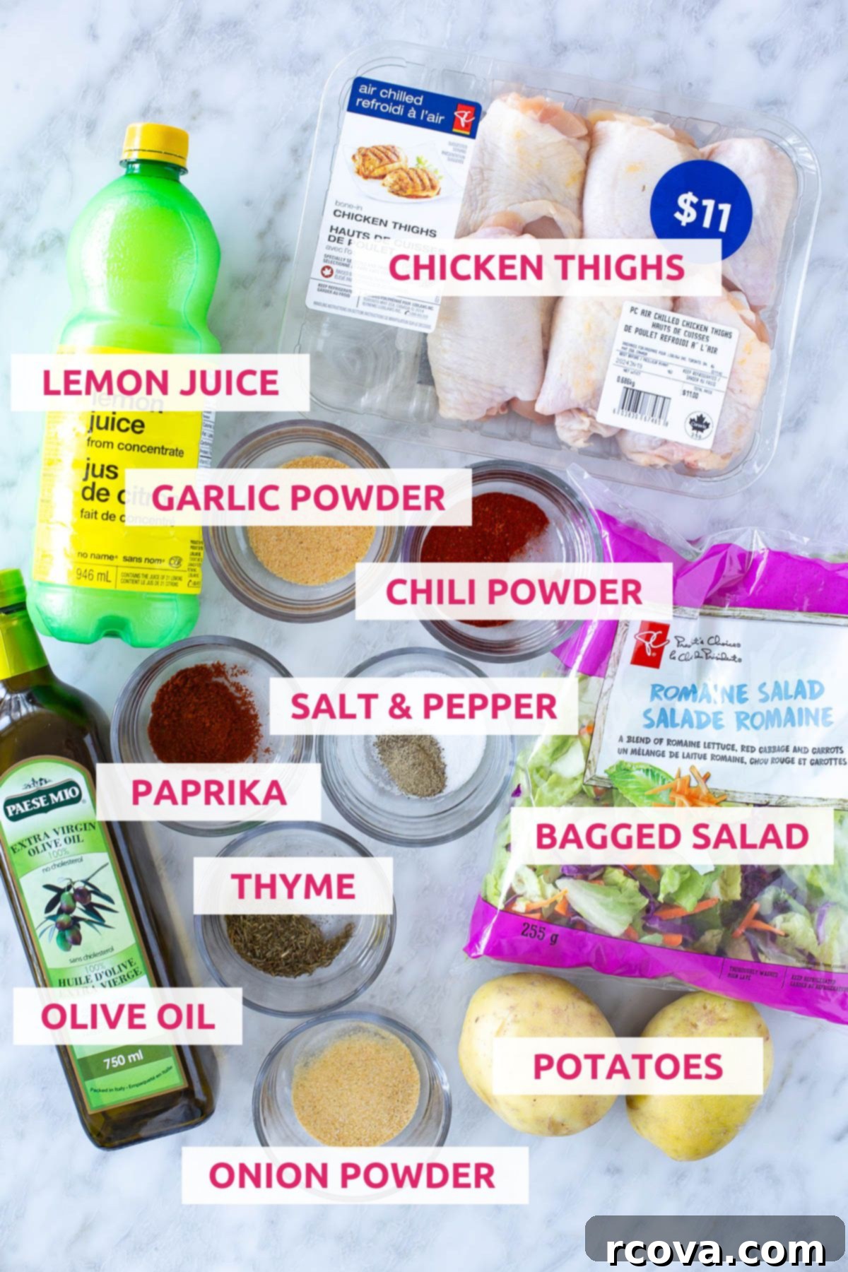 Succulent Baked Chicken Thighs with Crispy Skin 4 Ingredients for making baked chicken thighs: lemon juice, chicken thighs, garlic powder, chili powder, salt and pepper, paprika, thyme, bagged salad, olive oil, onion powder, potatoes laid out on a white surface.