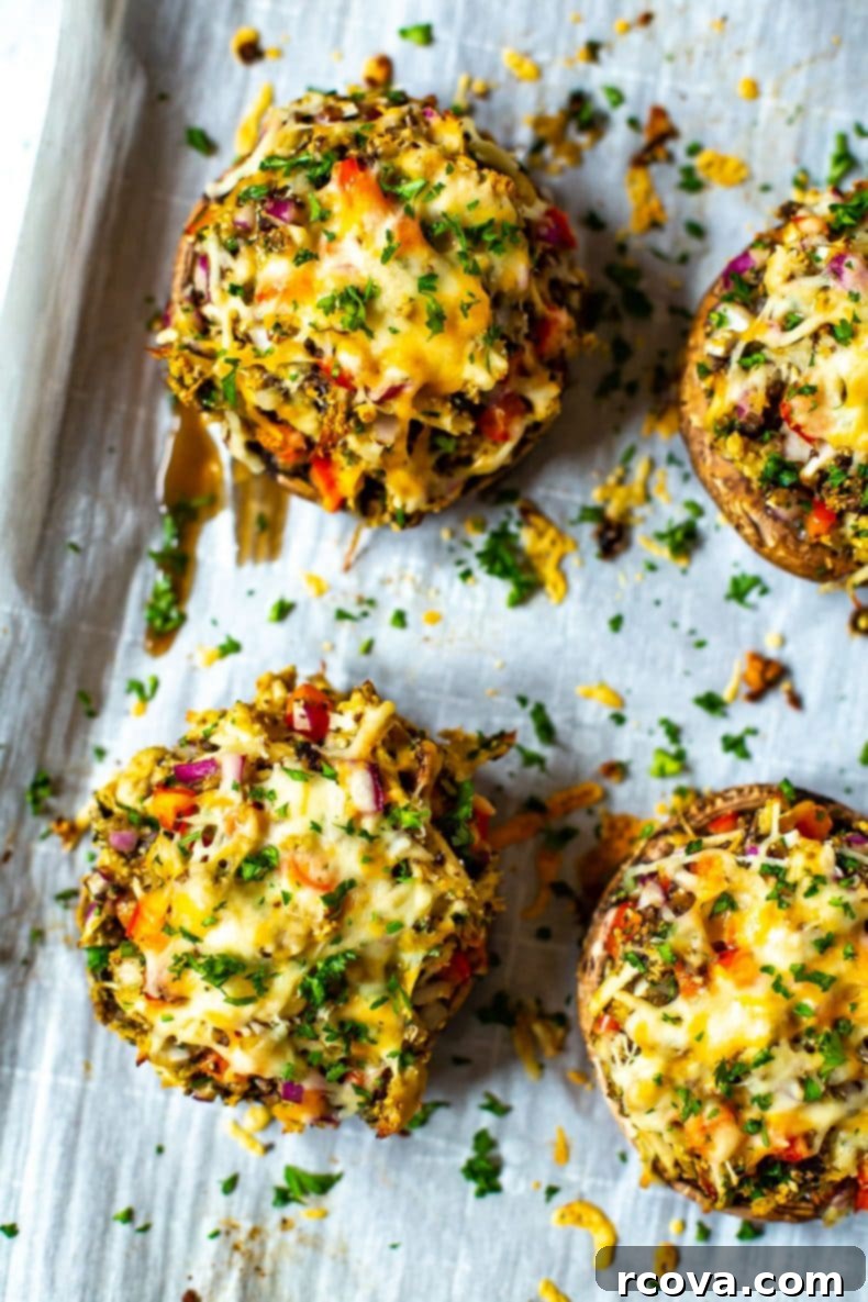 Perfectly Stuffed Portobello Mushrooms 2 Close-up of golden-brown stuffed portobello mushrooms, fresh out of the oven, garnished with parsley.
