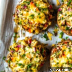 Perfectly Stuffed Portobello Mushrooms 8 Stuffed portobello mushrooms on a sheet pan lined with parchment paper, baked to perfection.